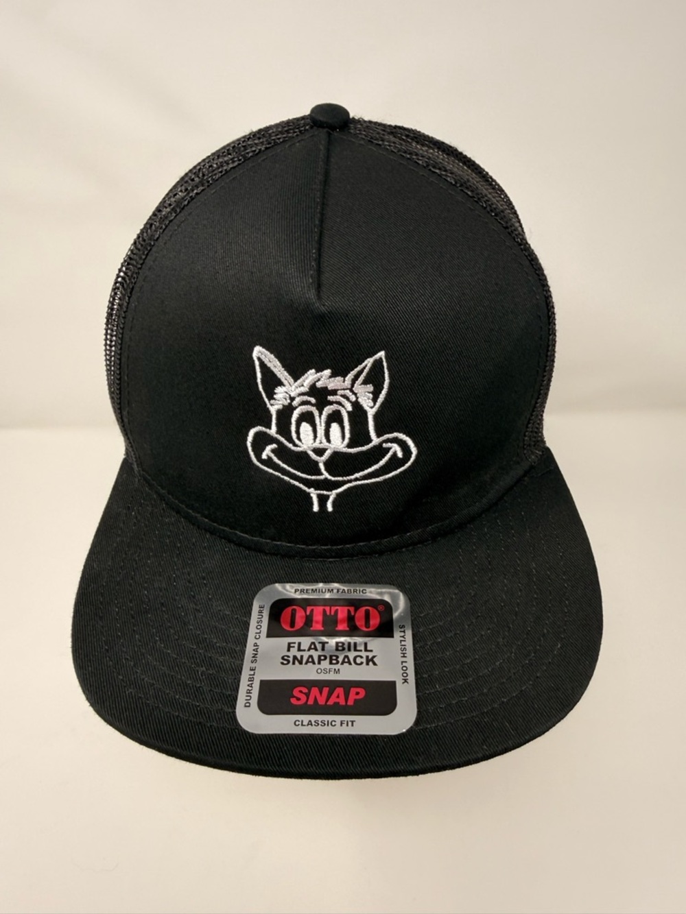 OTTO brand flat bill snapback trucker hat with an embroidered cartoon cat logo.